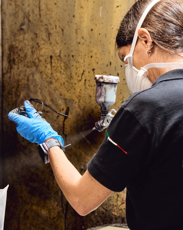 Master craftsman inspecting custom eyewear frame components