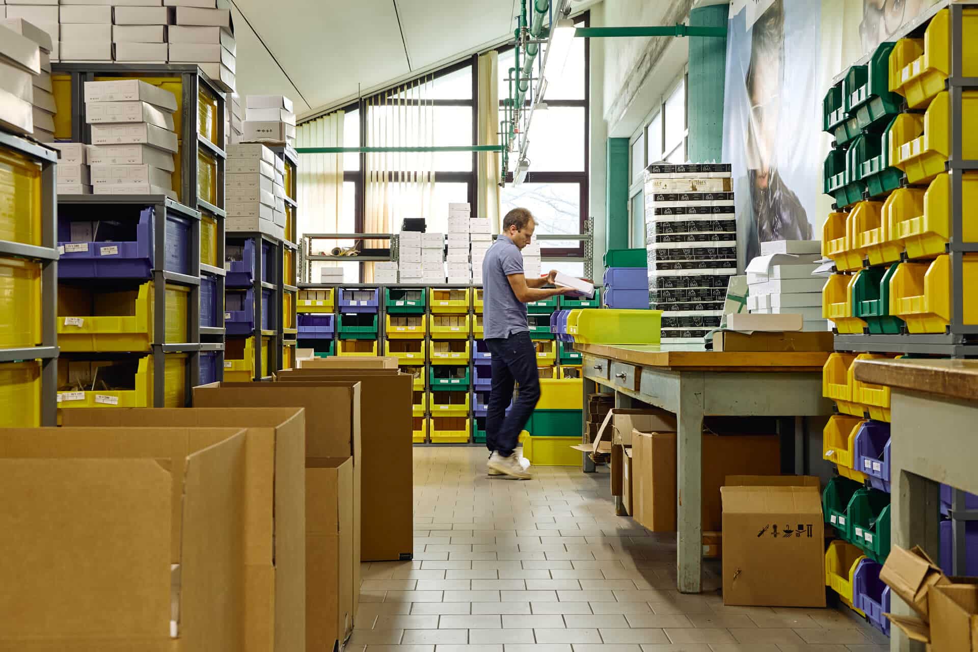 Artisan hand-finishing acetate eyewear frames at the IOVES Cadore plant